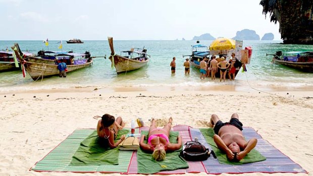 Tourists are flocking to Thailand's beach resorts as they avoid the political turmoil in Bangkok.