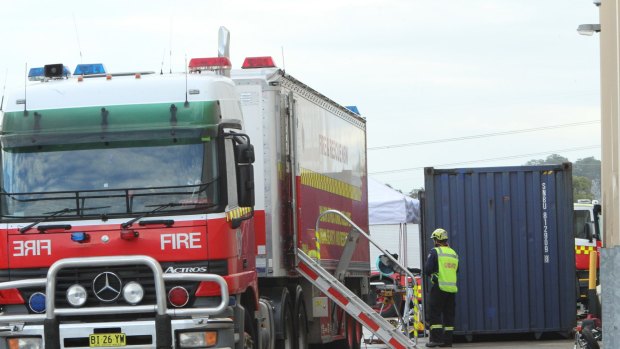 Two men were killed and another seriously injured when a stack of timber collapsed while being loaded in a shipping container at Wetherill Park.