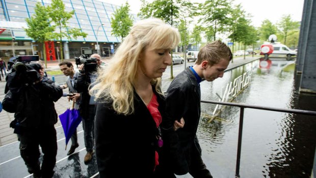 Grieving: The widow and son of linesman Richard van Nieuwenhuizen arrive at court.