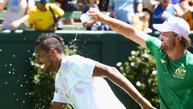 MELBOURNE, AUSTRALIA - FEBRUARY 04: Nick Kyrgios of Australia has a drink poured on him after winning the tie against Czech Republic during the first round World Group Davis Cup tie between Australia and the Czech Republic at Kooyong on February 4, 2017 in Melbourne, Australia. (Photo by Robert Prezioso/Getty Images)