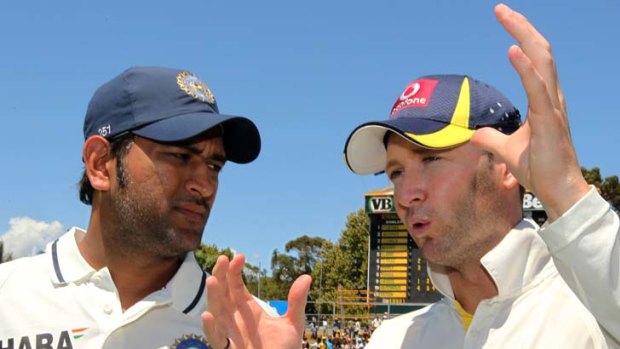 Indian captain MS Dhoni and Australian skipper Michael Clarke chat after Australia won the third cricket Test match by an innings and 37 runs.