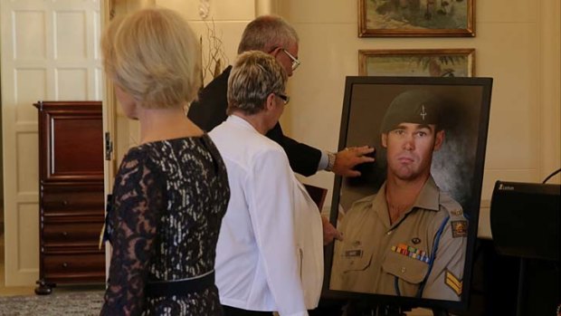 Doug and Kaye Baird with a portrait of their late son Corporal Cameron Baird.