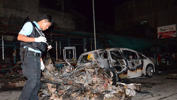A policeman at the site of one of the blasts in Thailand's Sungai Golok district.