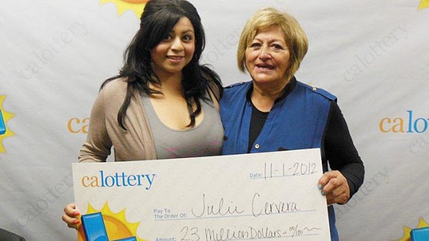 Charliena Borunda poses with her mother, Julie Cervera after the pair received their oversized cheque for their oversized lottery prize.