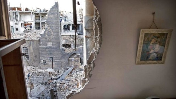 Devastation: A picture still hangs on the wall of a partially destroyed house belonging to a Christian family in the besieged city of Homs.