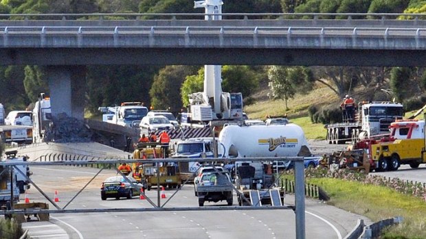 Authorities assess the damaged pylon at the crash site at the Ferntree Gully on-ramp.