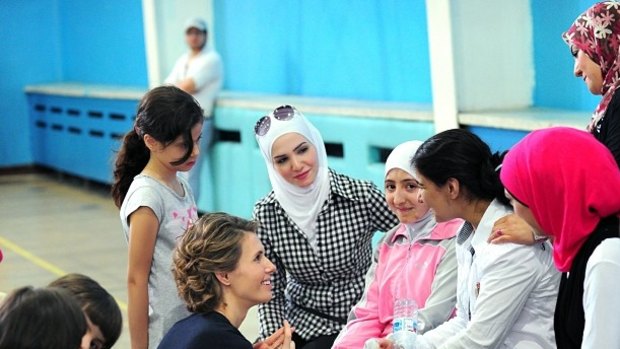 Asma al-Assad speaks to young women in 2013.