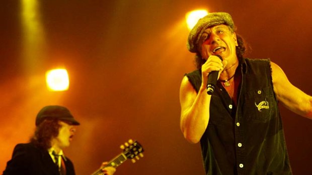 Guitarist Angus Young and singer Brian Johnson of legendary Australian rock band AC/DC performs in concert.