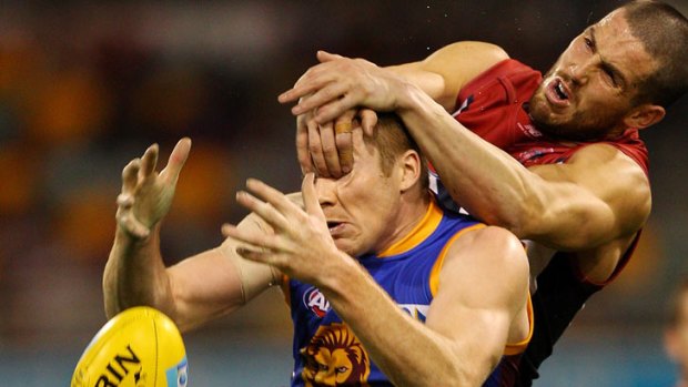 Ryan Harwood of the Lions and James Magner of the Demons compete for a mark during the round 14 AFL match between the Brisbane Lions and the Melbourne Demons at The Gabba on July 1, 2012 in Brisbane, Australia.