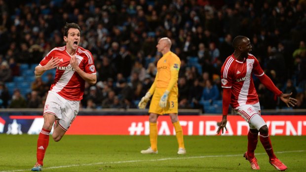 Middlesbrough's Spanish striker Kike and Middlesbrough's Ghanaian midfielder Albert Adomah (R) celebrate after Kike scored their second goal during the FA Cup fourth-round match against Manchester City.