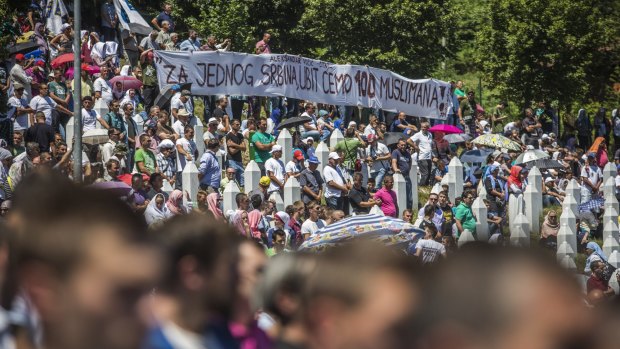 Protesters at the Potocari cemetery hold a banner quoting Aleksandar Vucic, who once said that "For one Serbian we are going to kill 100 Muslims".