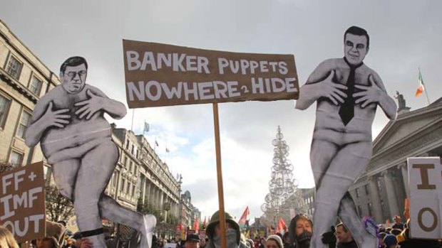 Outrage . . . protesters marching in Dublin at  the weekend hold up placards depicting the Prime Minister, Brian Cowen, left, and the Finance Minister, Brian Lenihan.