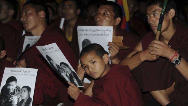 Buddhist monks and nuns take part in a candlelight protest at a temple in Dharamsala after the death of a young monk by self-immolation in Tibet.
