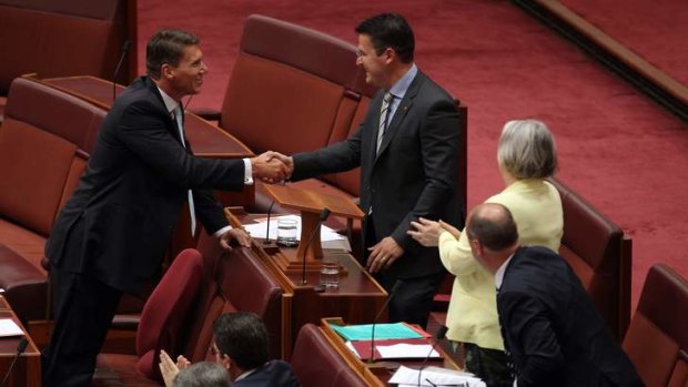 Senator Cory Bernardi congratulates Senator Zed Seselja after he delivered his maiden speech in the Senate.