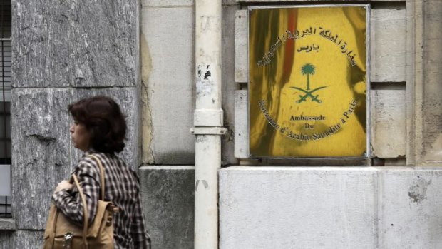 A woman walks past the entrance of the Saudi Arabian Embassy in Paris.
