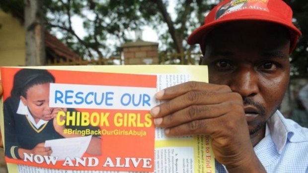 A Nigerian man holds a flyer campaigning for the release of the missing schoolgirls.