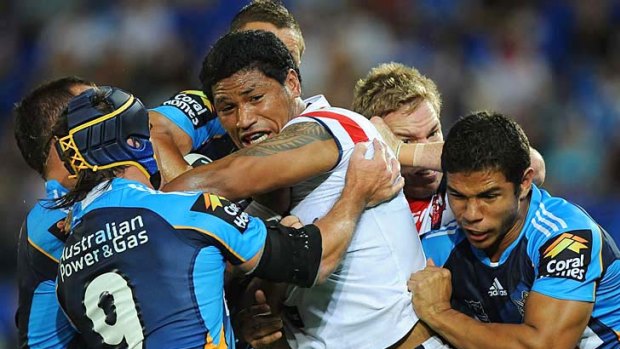Titanic struggle: Rooster Frank-Paul Nuuausala takes on the Gold Coast defence.