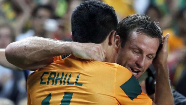 Australia's Tim Cahill hugs captain Lucas Neill after scoring a goal during the international friendly against Costa Rica.