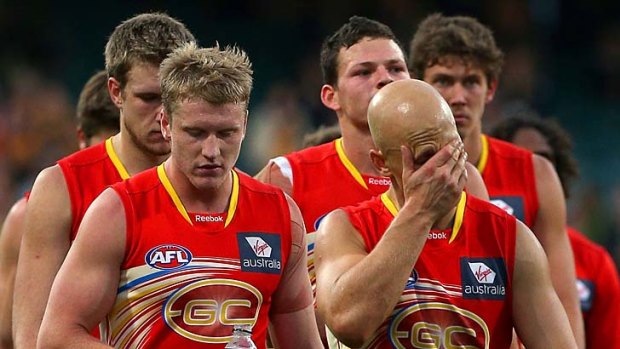 Dejected: Gary Ablett leads the Suns off the ground yesterday.