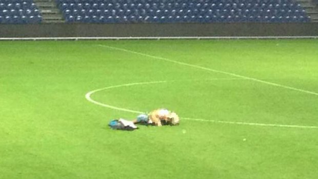 A pixellated version of a photo circulating on Twitter of a couple's amorous embrace on the field of Brondby football club in Denmark.
