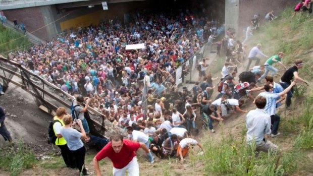 People flee during a mass panic  at a techno festival in Duisburg, Germany in 2010.