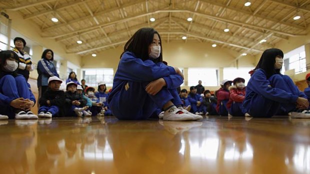 With their faces covered by masks, these children are restricted to indoor activities at Fukushima city's youth centre gymnasium.
