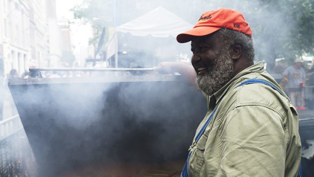 ‘‘Pitmaster’’ Ed Mitchell roasts whole pigs in a custom-made barbecue in his North Carolina restaurant.