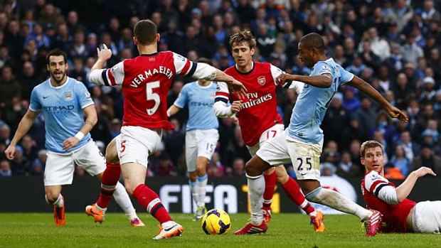 Manchester City's Fernandinho (second right) scores his second goal against Arsenal.