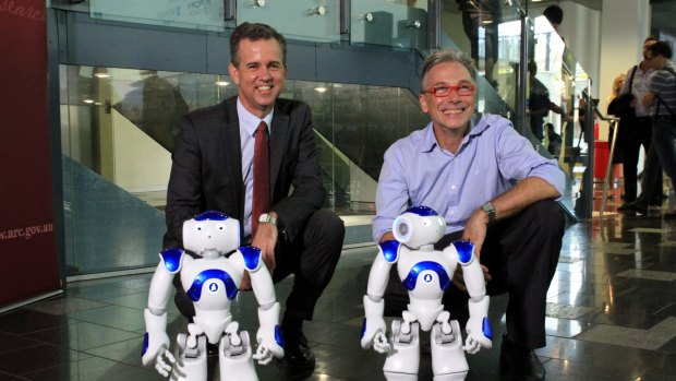 Professor Gordon Wyeth, Executive Dean of the science and engineering faculty at Queensland University of Technology  Australian Centre for Robotic Vision director Professor Peter Corke play with the NAO robots.