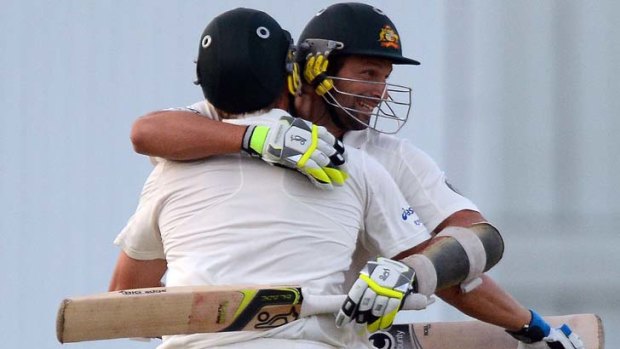Winners are huggers: Ryan Harris (left) and Ben Hilfenhaus celebrate after scoring the winning runs in the first Test.