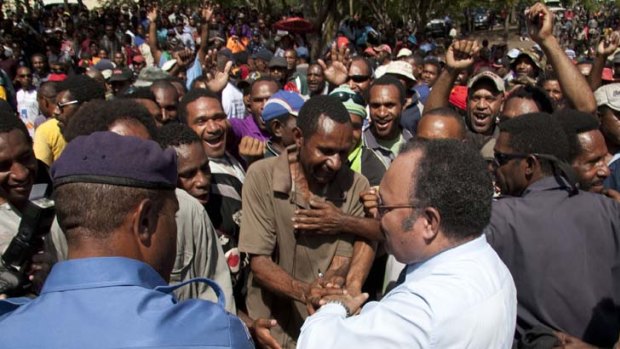 Peter O'Neill greets protest supporters in Port Moresby.