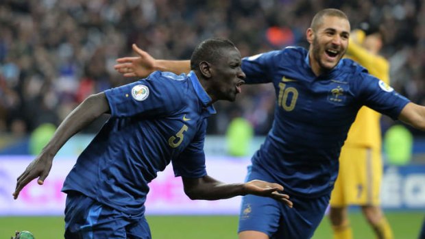 Mamadou Sakho of France, left, celebrates his side's third goal with Karim Benzema.