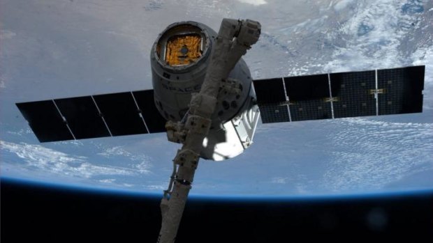 The SpaceX Dragon commercial cargo spacecraft is grappled to the International Space Station in April.