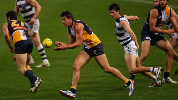 Andrew Embley of the Eagles handballs during the match between the West Coast Eagles and the Geelong Cats at Patersons Stadium.