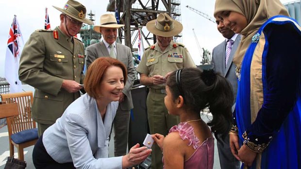 Recognition ... Julia Gillard hands the Defence Family Pin to serviceman Maleek Jamaldeen's family.