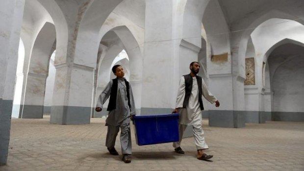 The work begins: Afghan election workers move election material into a polling station in Herat.