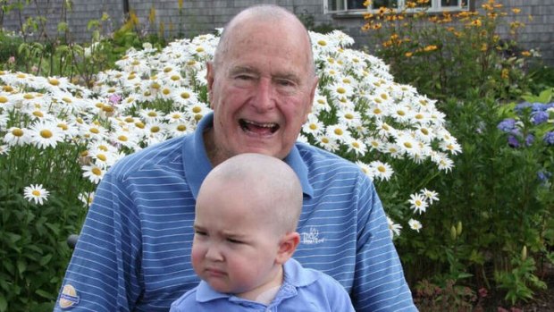 Former US President George H. W. Bush poses with his head shaved to show support for two year-old Patrick, the son of a detail member who is being treated for leukaemia.