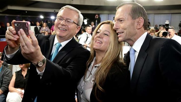 A woman requests a photo with Prime Minister Kevin Rudd and Opposition Leader Tony Abbott at Rooty Hill RSL in Western Sydney.