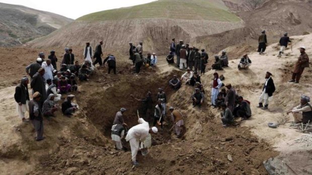 Villagers gather at the site of the landslide in Badakhstan province on Sunday.