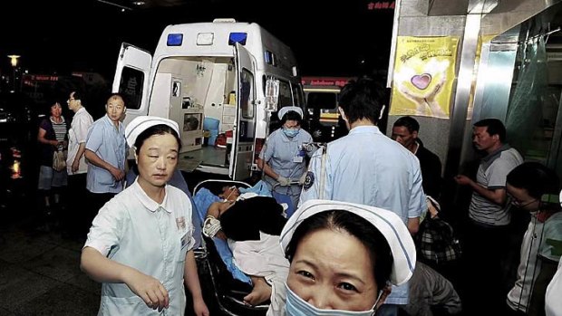 An injured man from a Foxconn factory, on a stretcher, arrives at a hospital in Chengdu on May 20, 2011.