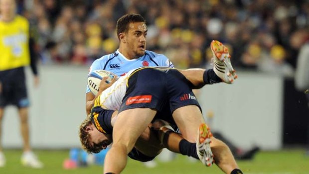 Over and out ... Peter Betham feels the full force of Brumbies defence.