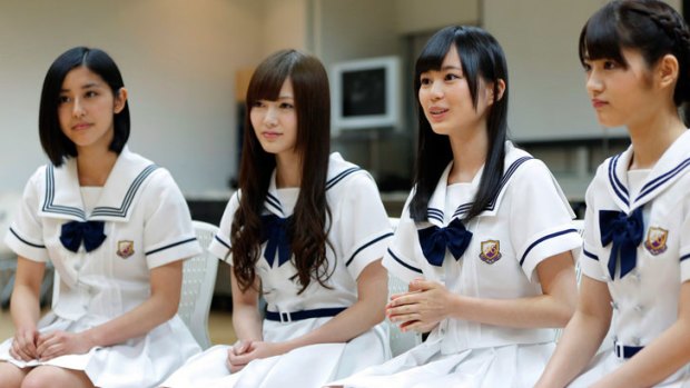 Erika Ikuta, a member of Sony's Japanese girl group Nogizaka 46, second right, speaks while fellow members Chiharu Saito, from left, Mai Shiraishi and Yumi Wakatsuki listen during an interview in Tokyo,