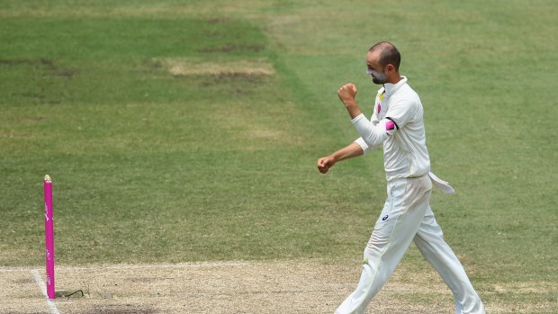 Turning opinion: Nathan Lyon celebrates the wicket of Bhuvneshwar Kumar in the first innings. 
