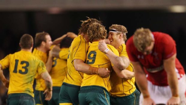 Last gasp &#8230; Wallabies players celebrate with relief after overcoming a spirited Wales in Melbourne on Saturday.