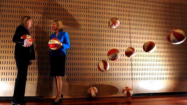 In the air: Basketball Australia chairwoman Kristina Keneally with Opals coach Carrie Graf.