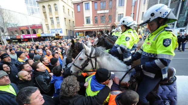Police and striking CFMEU workers clash.