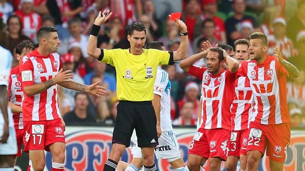 Heart players react as referee Ben Williams gives Patrick Kisnorbo a red card.