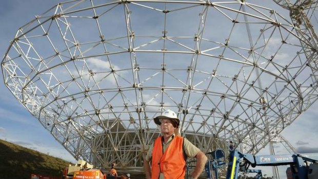 Civil technician David True in front of DSS-35 a new 34 m beam waveguide antenna being constructed at the Canberra Deep Space Communication Complex in Tidbinbilla.