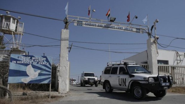 UN peacekeepers leave their main headquarters next to the Quneitra crossing, the only border crossing between Israel and Syria, in the Golan Heights.