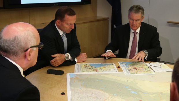 Prime Minister Tony Abbott and ASIO director-general Duncan Lewis look at the secret-but-not secret maps at ASIO Headquarters on Wednesday.
